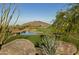 Picturesque golf course with a serene pond reflecting the clear blue sky and surrounding greenery at 37200 N Cave Creek Rd # 1013, Scottsdale, AZ 85262