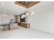 Open kitchen featuring modern appliances, gas cooktop, range hood, black marble countertops, and backyard access at 37200 N Cave Creek Rd # 1013, Scottsdale, AZ 85262