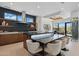 Gourmet kitchen with black marble island, seating, stainless steel appliances, and modern pendant lighting at 37200 N Cave Creek Rd # 1013, Scottsdale, AZ 85262
