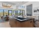 Open-concept kitchen with a black marble island, modern sink, and seamless flow to the living area at 37200 N Cave Creek Rd # 1013, Scottsdale, AZ 85262