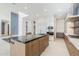 A modern kitchen featuring an island with seating and stainless steel appliances at 37200 N Cave Creek Rd # 1013, Scottsdale, AZ 85262