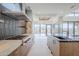 Open kitchen with modern appliances, gas cooktop, range hood, and island overlooking the backyard and mountain views at 37200 N Cave Creek Rd # 1013, Scottsdale, AZ 85262