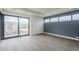 Hardwood floor living room featuring backyard access and a blue accent wall at 37200 N Cave Creek Rd # 1013, Scottsdale, AZ 85262