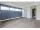 Spacious living room features hardwood floors and blue accent wall at 37200 N Cave Creek Rd # 1013, Scottsdale, AZ 85262