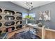 Stylish home office with custom shelving, modern decor, and a comfortable workspace at 37200 N Cave Creek Rd # 1013, Scottsdale, AZ 85262