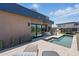 Stunning outdoor pool area featuring a pool, tanning chairs, artificial turf and a modern desert home at 37200 N Cave Creek Rd # 1013, Scottsdale, AZ 85262