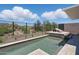 Gorgeous swimming pool featuring travertine tile, desert views, and a tranquil waterfall feature at 37200 N Cave Creek Rd # 1013, Scottsdale, AZ 85262