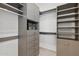 Organized walk-in closet featuring built-in shelving, drawers, and ample storage space at 37200 N Cave Creek Rd # 1013, Scottsdale, AZ 85262