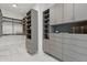 A spacious walk-in closet featuring custom shelving, drawers, and ample storage space at 37200 N Cave Creek Rd # 1013, Scottsdale, AZ 85262