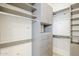 Spacious walk-in closet with built-in shelving, drawers, and ample hanging space for organization at 37200 N Cave Creek Rd # 1013, Scottsdale, AZ 85262