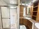 Bright bathroom featuring a glass shower, wood cabinets, and double sinks at 381 S Gypsum Dr, Apache Junction, AZ 85119