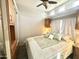 Cozy bedroom with a ceiling fan, cabinets, and built-in closet, offering a comfortable retreat at 381 S Gypsum Dr, Apache Junction, AZ 85119