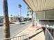 A scenic community street with palm trees and well-maintained mobile homes, offering peaceful living at 381 S Gypsum Dr, Apache Junction, AZ 85119
