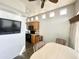 Bright dining area with large windows, a ceiling fan, and kitchen view at 381 S Gypsum Dr, Apache Junction, AZ 85119