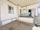 Covered front porch with sitting area offers a tranquil space to unwind and enjoy the outdoors at 381 S Gypsum Dr, Apache Junction, AZ 85119