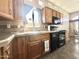 Beautiful kitchen with wooden cabinets and black appliances at 381 S Gypsum Dr, Apache Junction, AZ 85119