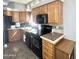 Traditional kitchen with black appliances and oak cabinets at 381 S Gypsum Dr, Apache Junction, AZ 85119
