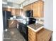 Kitchen features wood cabinets, black appliances, and a tile backsplash at 381 S Gypsum Dr, Apache Junction, AZ 85119