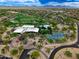 Aerial view of a community center featuring a pool, tennis courts, green spaces and mature landscaping at 3841 E Patrick Ln, Phoenix, AZ 85050
