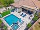 Aerial view of a private backyard pool and patio with lounge seating and mature landscaping at 3841 E Patrick Ln, Phoenix, AZ 85050