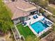 An aerial view of a backyard with a pool, spa, patio, and small patch of grass at 3841 E Patrick Ln, Phoenix, AZ 85050