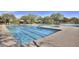 Large community pool with lap lanes, hot tub, lounge seating, and shaded cabanas at 3841 E Patrick Ln, Phoenix, AZ 85050