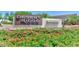 Desert Ridge Marketplace entrance sign surrounded by vibrant flowers and lush greenery at 3841 E Patrick Ln, Phoenix, AZ 85050