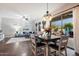 Open concept dining area featuring modern chandelier and seamless flow to the outdoor patio at 3841 E Patrick Ln, Phoenix, AZ 85050