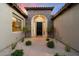 Inviting front entryway with a stone archway, desert landscaping, and plenty of curb appeal at 3841 E Patrick Ln, Phoenix, AZ 85050