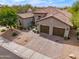 Charming home with a tile roof, a two-car garage, and lovely desert landscaping at 3841 E Patrick Ln, Phoenix, AZ 85050