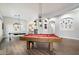 Well-lit game room with wood floors, pool tables, and lots of space for entertaining guests at 3841 E Patrick Ln, Phoenix, AZ 85050