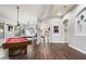 Spacious game room with dark wood floors, pool table, and other areas for entertaining at 3841 E Patrick Ln, Phoenix, AZ 85050