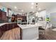 Gourmet kitchen with island, granite counters, stainless appliances, and rich dark wood cabinetry at 3841 E Patrick Ln, Phoenix, AZ 85050