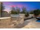 Built-in outdoor grill area with stone countertop, perfect for outdoor cooking and entertaining in style at 3841 E Patrick Ln, Phoenix, AZ 85050