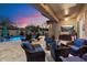 Beautiful outdoor patio with pool, lounge chairs, and comfortable seating area for entertaining guests at 3841 E Patrick Ln, Phoenix, AZ 85050