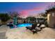 Sparkling pool surrounded by a stone patio, lounge chairs, and lush landscaping in a private backyard at 3841 E Patrick Ln, Phoenix, AZ 85050