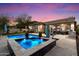 Luxurious backyard featuring a beautiful pool and spa combo, complete with outdoor seating and a covered patio area at 3841 E Patrick Ln, Phoenix, AZ 85050