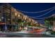Vibrant night street view lined with shops, restaurants, and decorative string lights at 3841 E Patrick Ln, Phoenix, AZ 85050
