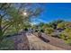 Picturesque walking path surrounded by desert landscaping and mature trees at 3841 E Patrick Ln, Phoenix, AZ 85050