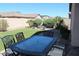 Private backyard featuring outdoor dining area, artificial turf, and a fire pit at 3850 E Balsam Dr, Chandler, AZ 85286