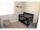 Cozy Bedroom with dark wood crib, neutral tones, and dinosaur-themed decorations for a playful atmosphere at 3850 E Balsam Dr, Chandler, AZ 85286
