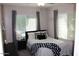 Bright bedroom with white and black bedding, string lights, and natural light for a cozy retreat at 3850 E Balsam Dr, Chandler, AZ 85286