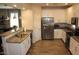 Modern kitchen features white cabinets, granite countertops, stainless steel appliances, and wood-look tile flooring at 3850 E Balsam Dr, Chandler, AZ 85286