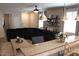 Inviting living room featuring a granite-topped kitchen island, plush black couch, and stylish decor for relaxed living at 3850 E Balsam Dr, Chandler, AZ 85286