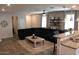 Cozy living area with modern décor, kitchen bar, and tile floors at 3850 E Balsam Dr, Chandler, AZ 85286