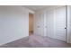 Bedroom features carpet floors, closet doors, and bright natural light at 39965 W Bunker Dr, Maricopa, AZ 85138
