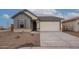 Charming single-story home with a two-car garage and neutral-toned exterior at 39965 W Bunker Dr, Maricopa, AZ 85138