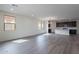 Bright open-concept living area showcasing recessed lighting and modern gray wood flooring at 39965 W Bunker Dr, Maricopa, AZ 85138