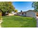 A sprawling, grassy backyard features a traditional single-story home at 4314 E Montecito Ave, Phoenix, AZ 85018