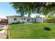 Enjoy a spacious backyard with lush grass, mature trees and a fire pit at 4314 E Montecito Ave, Phoenix, AZ 85018
